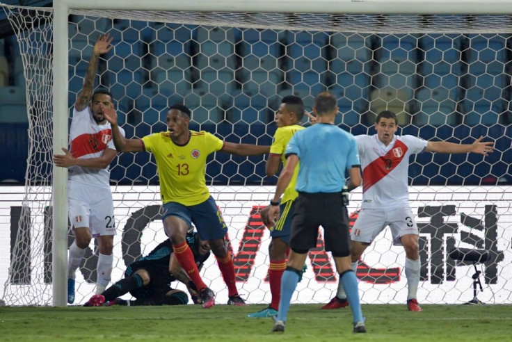 Peru's players celebrate after Colombia's Yerry Mina (2nd left) scored an unfortunate own goal that won the game