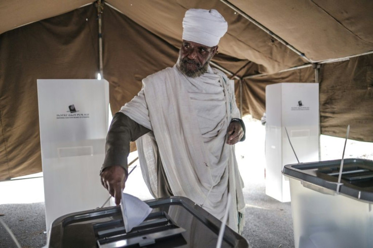 An Ethiopian Orthodox priest casts his ballot at a polling station in the city of Bahir Dar, Ethiopia