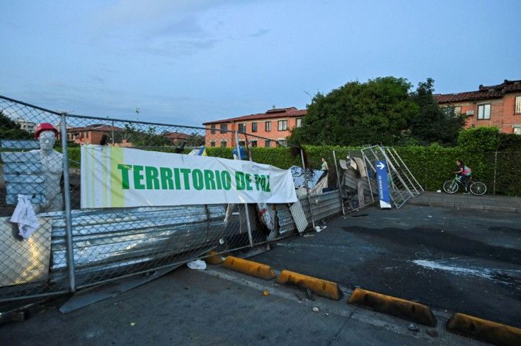 A banner declaring a "Peaceful Territory" is seen at a roadblock manned by anti-government protesters in Cali, Colombia