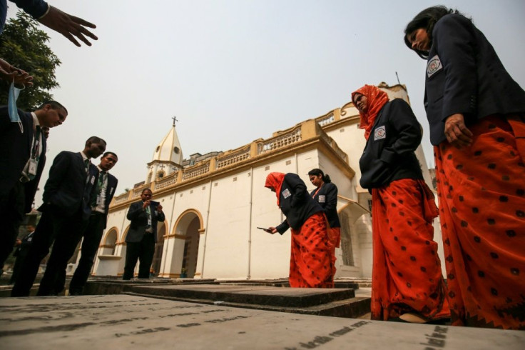 Several assistants help Ghosh maintain the church and feed the half a dozen stray dogs living in the grounds