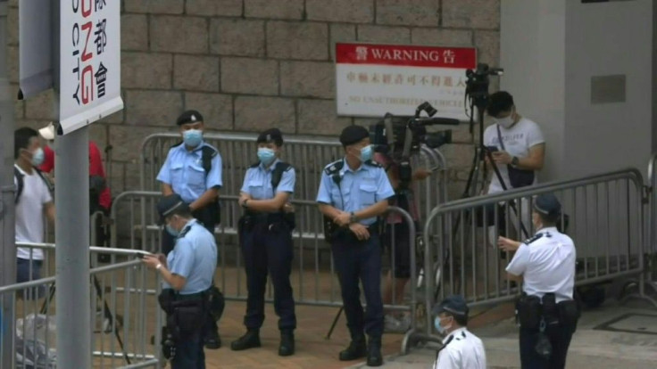 IMAGES Police and media stand outside Hong Kong's High Court as the first trial under Hong Kong's new national security law is set to begin on Wednesday without a jury, a landmark moment for the financial hub's fast-changing legal traditions.Tong Ying-