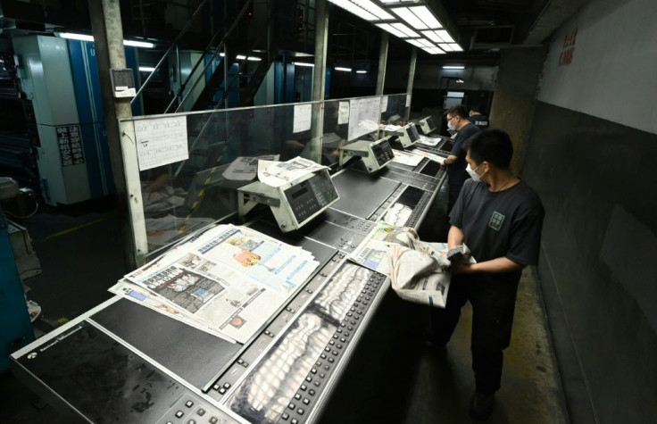 Staff work at the printing facility of Apple Daily in Hong Kong