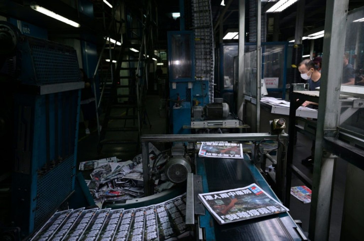 Apple Daily employees work in the printing room for the paper's last edition in Hong Kong early on June 24, 2021