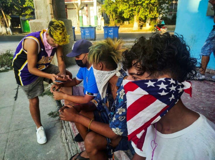 A youngster wears a handkerchief depicting the US flag as face mask, in Havana, on June 22, 2021