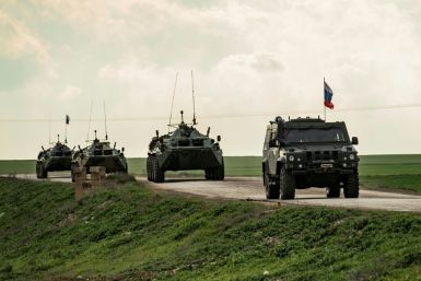 In this file photo taken on February 22, 2020 Russian military vehicles patrol the M4 highway in the northeastern Syrian Hasakeh province on the border with Turkey