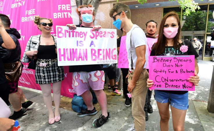 Britney Spears' fans and supporters hold signs as they gather outside the county courthouse in Los Angeles on June 23, 2021