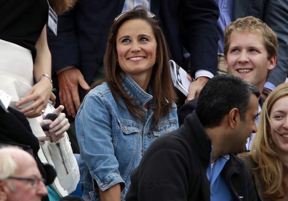 Pippa Middleton C, sister of Catherine, Britains Duchess of Cambridge smiles during the match between Andy Murray of Britain and Janko Tipsarevic of Serbia at the Queens Club Championships in west London June 9, 2011.