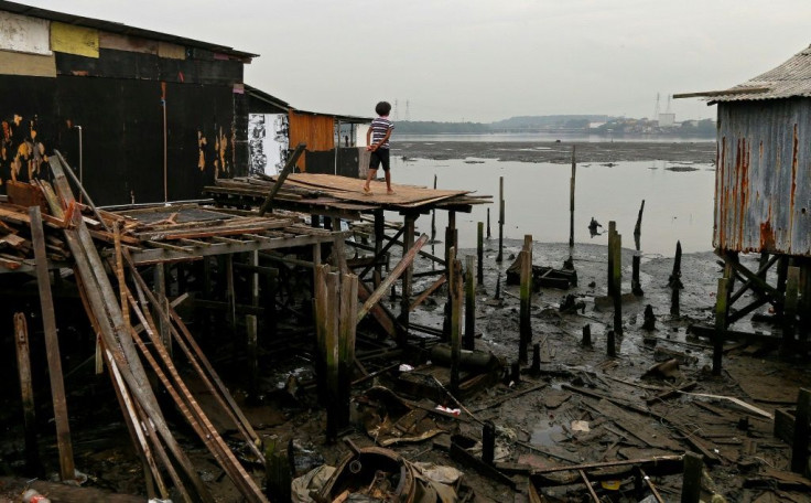 A resident stands on a platform on stilts at the Dique da Vila Gilda favela, in Santos, Sao Paulo state, Brazil, on June 10, 2021