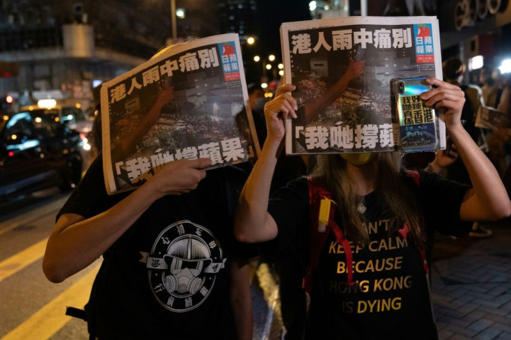 Two women hold up the final edition of the pro-democracy newspaper Apple Daily in Hong Kong early on June 24national security law, ending a 26-year run of taking on China's authoritarian leaders.
