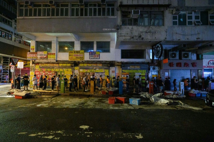 People queue for the last edition of the Apple Daily newspaper  in Hong Kong