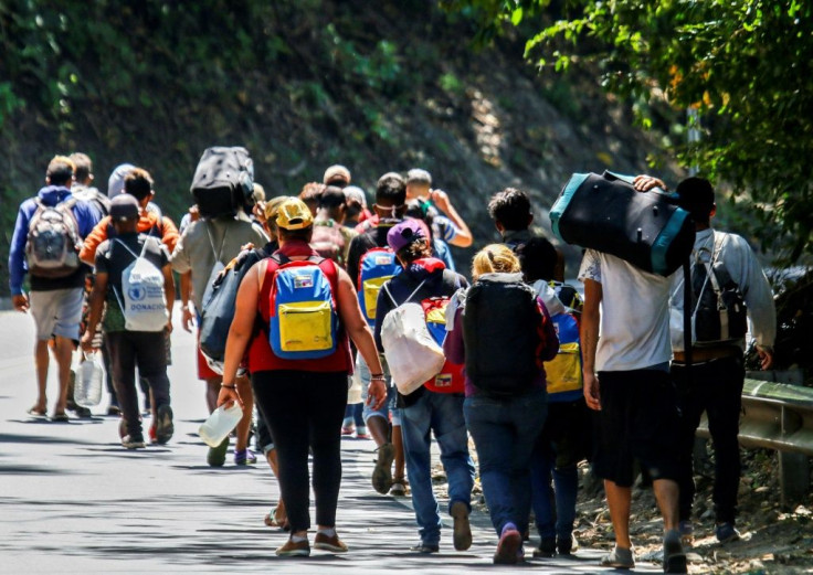 Venezuelan migrants walk along a highway in Cucuta, Colombia, on the border with Venezuela, on February 2, 2021, amid the COVID-19 pandemic