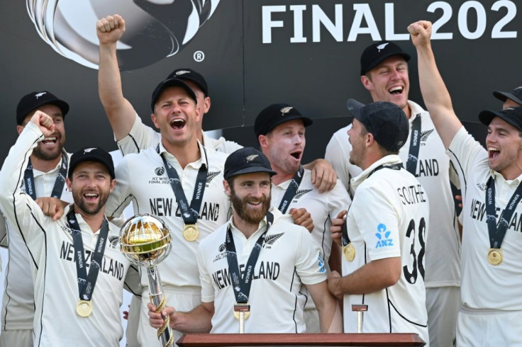 New Zealand's captain Kane Williamson (C) holds the winner's Mace as New Zealand players celebrate victory in the ICC World Test Championship Final against India in Southampton, England