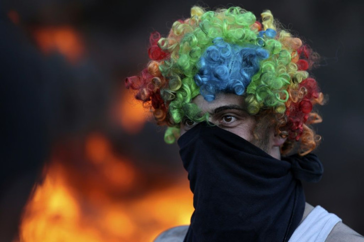 Palestinians burn tyres during a nighttime demonstration against the Jewish settlement outpost of Eviatar in the occupied West Bank