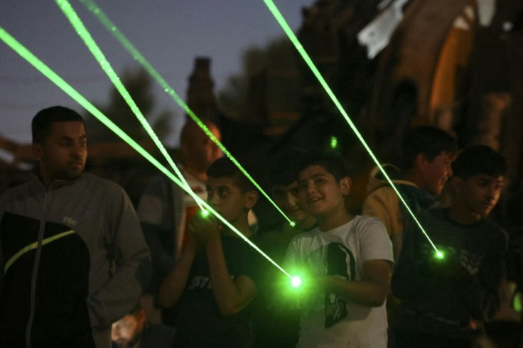 Lasers are directed towards the windows of homes in the settlement