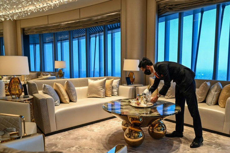 An employee is seen in a suite room of the J Hotel, the world's highest luxury hotel, in Shanghai
