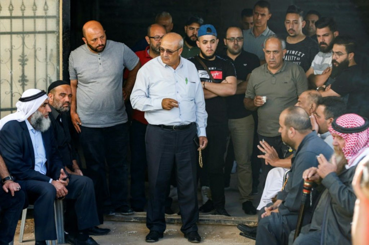 Male relatives of Palestinian human rights activist Nizar Banat gather at the family home to mourn his death in Palestinian Authority custody