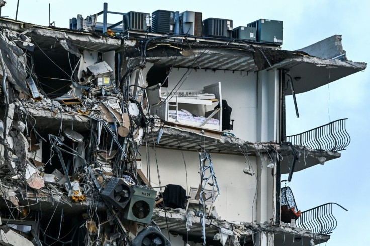 Rubble hangs from a partially collapsed building in Surfside north of Miami Beach, on June 24, 2021