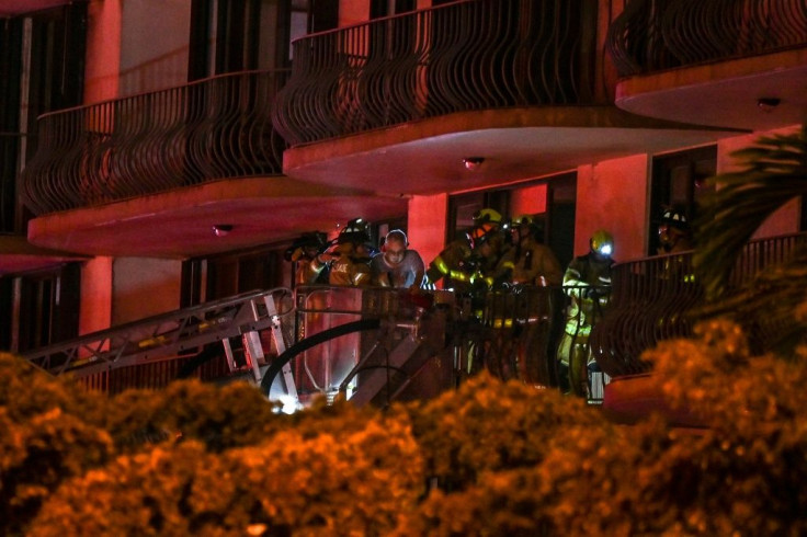 First responders rescue a resident from a partially collapsed residential building in Miami Beach, Florida, early June 24, 2021