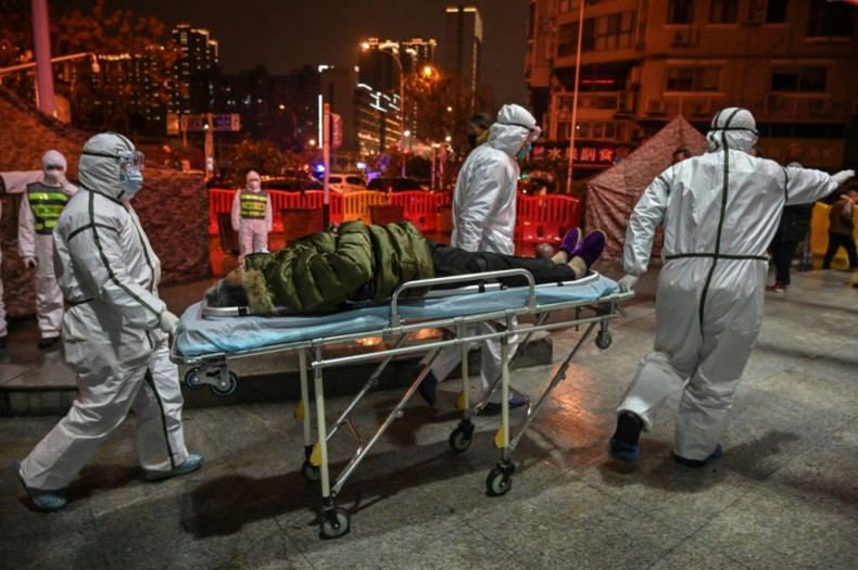 Medical staff arrive with a patient at the Wuhan Red Cross Hospital, in an image captured by Hector Retamal