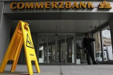 A man looks at his watch outside a branch of Commerzbank in Frankfurt