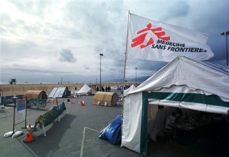 Medecins Sans Frontieres (flag pictured in California in 2000) said that three employees were found dead after the morning after they had lost contact with the medical charity during a trip