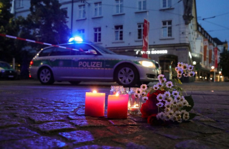 Flowers and candles placed at the scene of a deadly stabbing in Germany's Wuerzburg