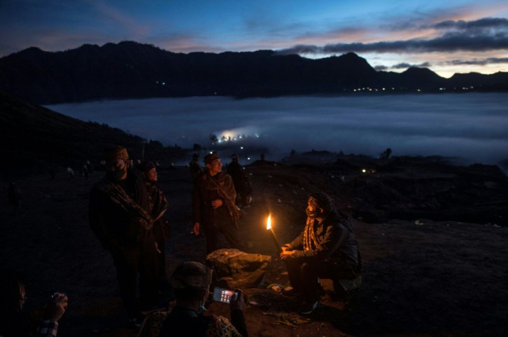 Tengger tribe people make their way to the summit of Mount Bromo to make offerings to the gods in Probolinggo, East Java, Indonesia