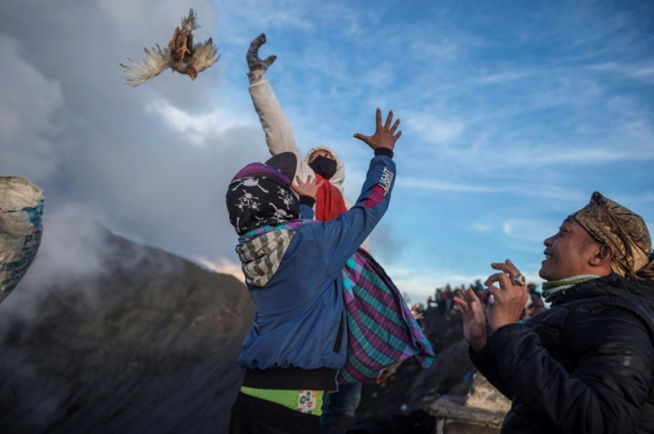Worshippers throw their offerings into the volcano of Mount Bromo as a sacrifice to the gods