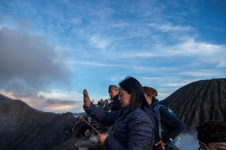 Tengger tribe people pray at the top of Mount Bromo