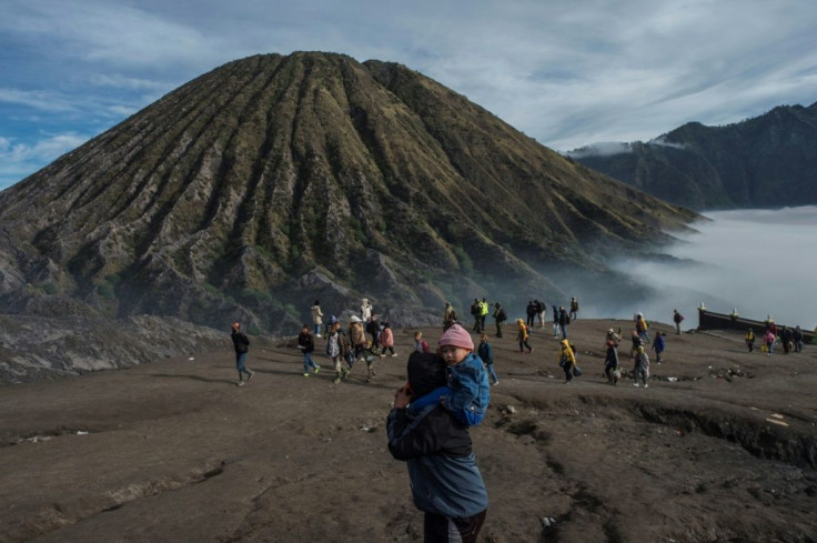 Every year people gather from the surrounding highlands to throw fruit, vegetables, flowers and even livestock into Mount Bromo's crater as part of the Yadnya Kasada festival