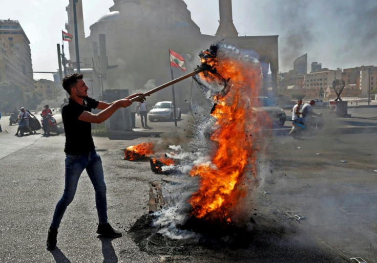 Demonstrators burn tyres in central Beirut on June 26, 2021, as they protest against dire living conditions