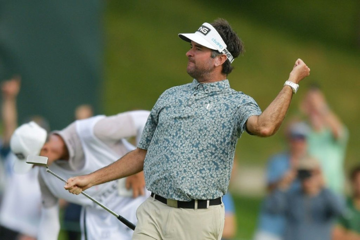 Bubba Watson delivers a left fist pump after sinking a 20-foot birdie putt at the 17th hole that helped give him a share of the 54-hole lead at the US PGA Travelers Championship