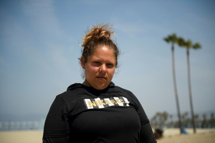 Denise Diangelo, who is living at Venice Beach and hopes to get into a shared housing program, stands for a portrait on June 16, 2021 at Venice Beach in Los Angeles, California