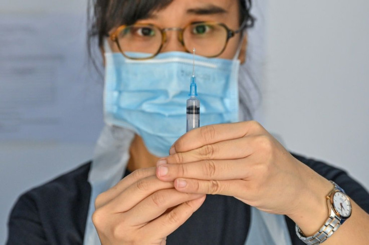 A medical staff member prepares to administer a dose of the Sinovac vaccine on a mobile vaccine truck in Kuala Lumpur, Malaysia