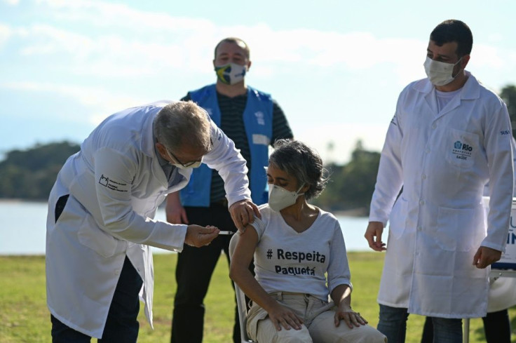 Health Minister Marcelo Queiroga administers a dose of AstraZeneca vaccine during a mass vaccination campaign in Rio de Janeiro on June 20, 2021; a scandal meantime has emerged around a multimillion-dollar order for an Indian vaccine