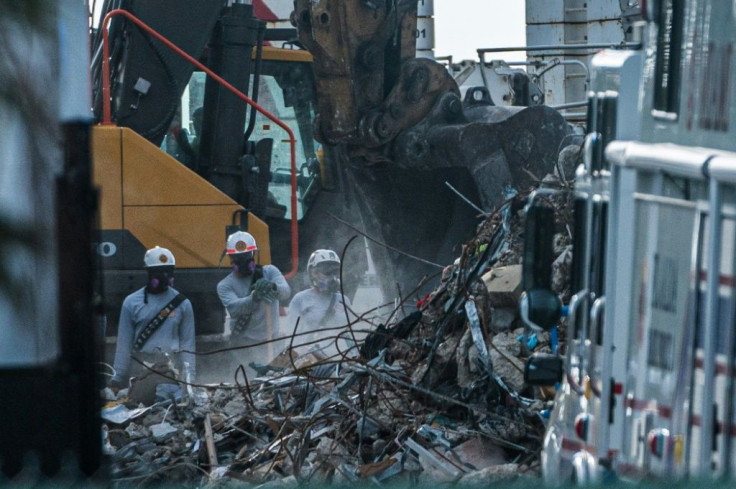 Search and rescue teams look for possible survivors in the partially collapsed 12-story Champlain Towers South building in Surfside, Florida