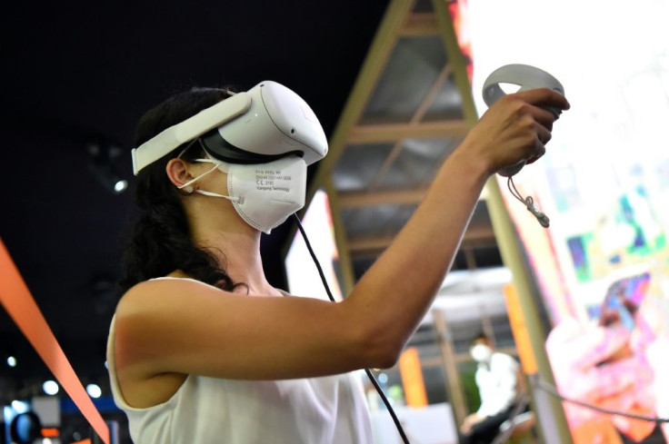 A woman tries virtual reality glasses at the Orange stand during the Mobile World Congress fair in Barcelona.