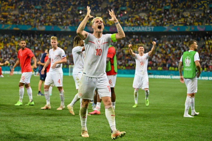 Switzerland's Granit Xhaka leads the celebrations after their victory over the world champions