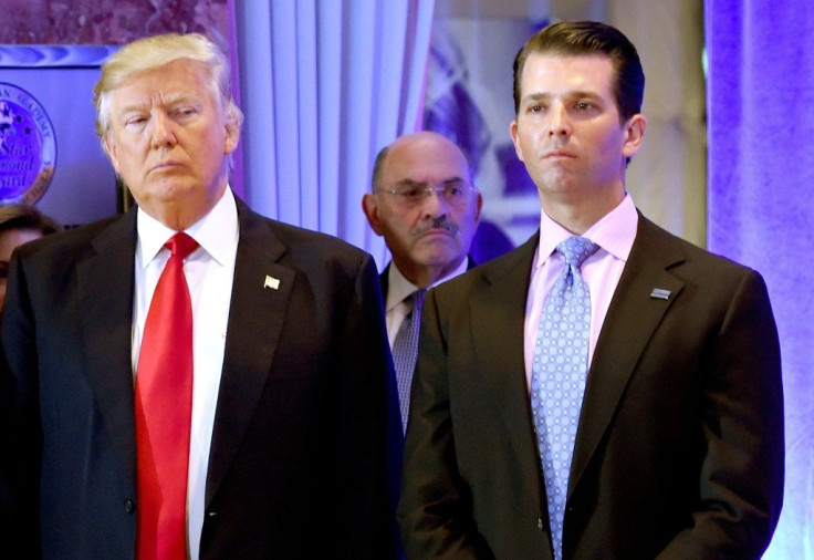 Then-president Donald Trump along with his son Donald, Jr., arrive for a press conference at Trump Tower in New York, as Allen Weisselberg (C), chief financial officer of The Trump, looks on January 11, 2017