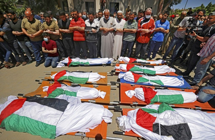 Palestinians in Gaza City pray during the funeral of a family of 10 who were killed in an Israeli air strike on the western Gaza Strip in May