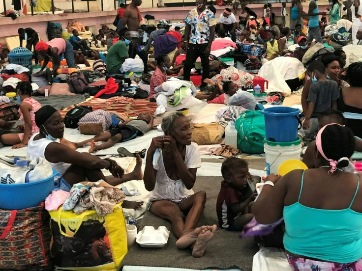 Hundreds of families take shelter from gang warfare in a sport center of the city of Carrefour, in the suburbs of Port-au-Prince, on June 16, 2021