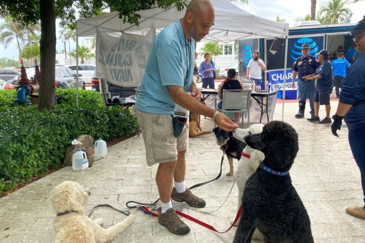 United Cajun Navy volunteer Jay Harris feeds dogs he brought for therapy in Surfside, Florida on June 28, 2021