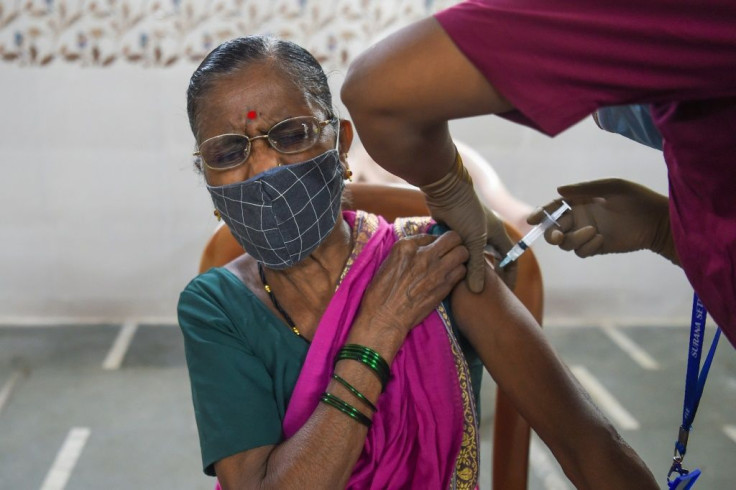 A resident reacts as she gets inoculated with a dose of AstraZeneca-Oxford's Covid-19 coronavirus vaccine at a centre in the Dharavi slums in Mumbai