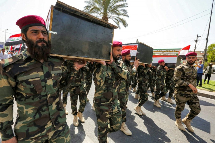 Members of Iraq's Hashed al-Shaabi paramilitary forces march in a symbolic funeral parade in the capital Baghdad, in remembrance of those killed in a US raid against one of the Hashed's brigades