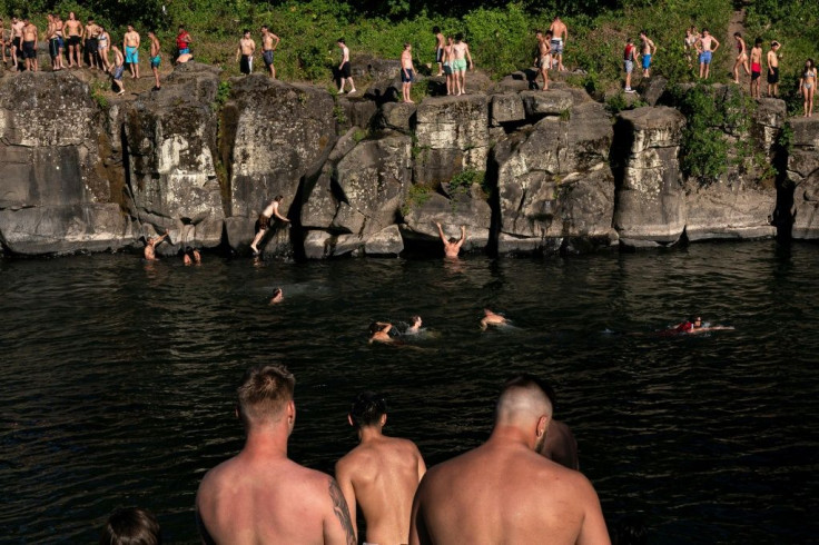 Staying cool as temperatures soar -- cliff divers line up along the Clackamas River at High Rocks Park on June 27, 2021 in Portland, Oregon