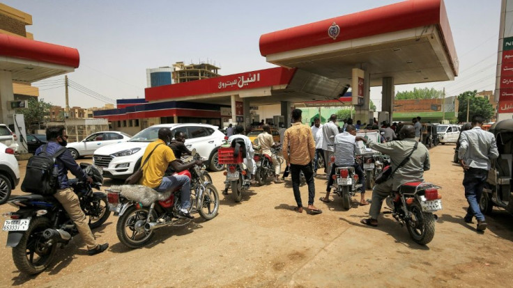 Motorcyclists queue-up for fuel at a petrol station in Sudan's capital Khartoum on June 10, 2021. Sudan has ended fuel subsidies as part of an IMF-backed reform programme, helping it secure a $2.5 bn loan from the financial institution