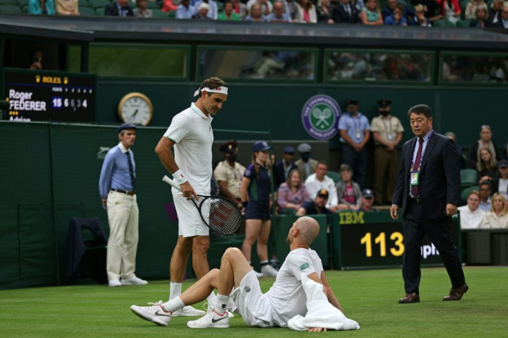 Swiss tennis legend Roger Federer moved into the second round of Wimbledon but the eight time champion did so with his match level at two sets each only for opponent Adrian Mannarino to injure hinmself in a fall
