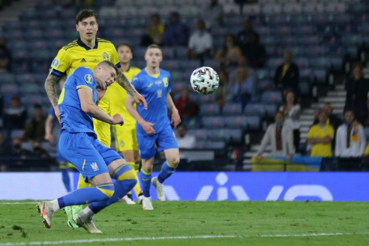 Heading to the quarter-finals: Artem Dovbyk (left) scored a dramatic late winner for Ukraine over Sweden