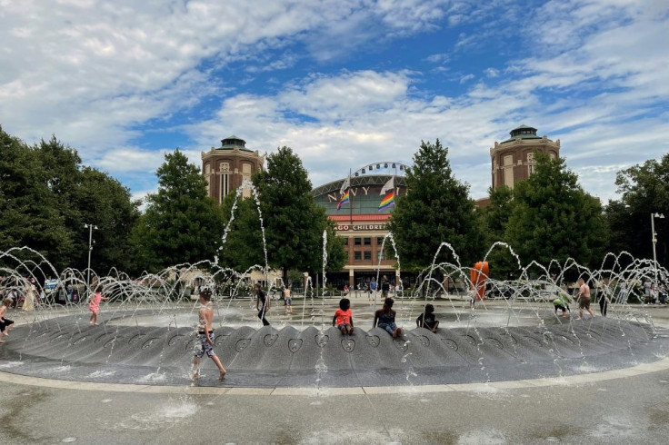 Kids play on a water fountain in downtown Chicago as they try to escape the heat