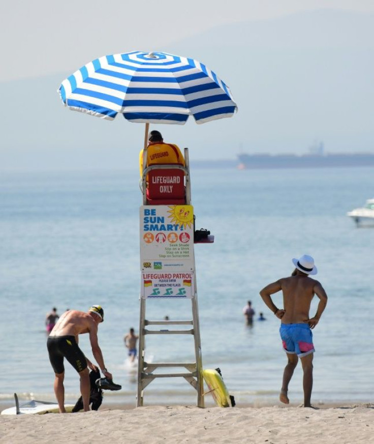 A lifeguard watches over Kits Beach, which is popular on hot days, in Vancouver